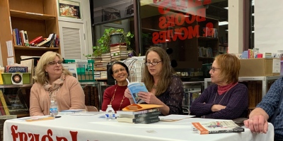 Kate Gingold reads aloud at a local author event.